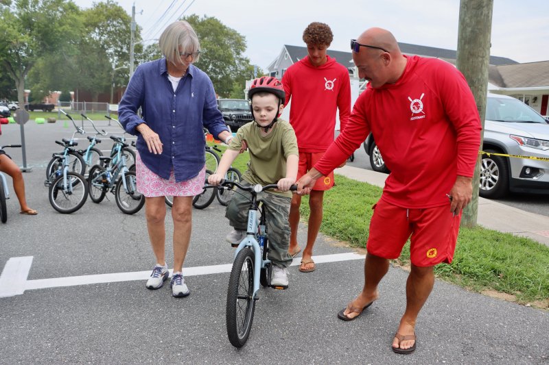 The Lewes Bicycle and Pedestrian Advisory Committee held a bike rodeo to teach safety to young riders, with help from the Lewes Beach Patrol. Shown are (l-r) Mary Roth, bike committee chair; Knox Brown; Eric Lewis, Lewes Beach Patrol; and Lt. Matt McDonough, Lewes Beach Patrol.
